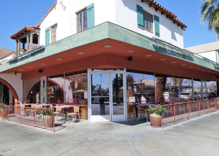 Exterior of building with tables and chairs