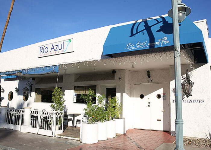 Exterior of building with tables and chairs