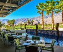 Exterior of building with tables, chairs, and view of canyons