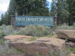 sign of museum with boulders and grass surrounding it