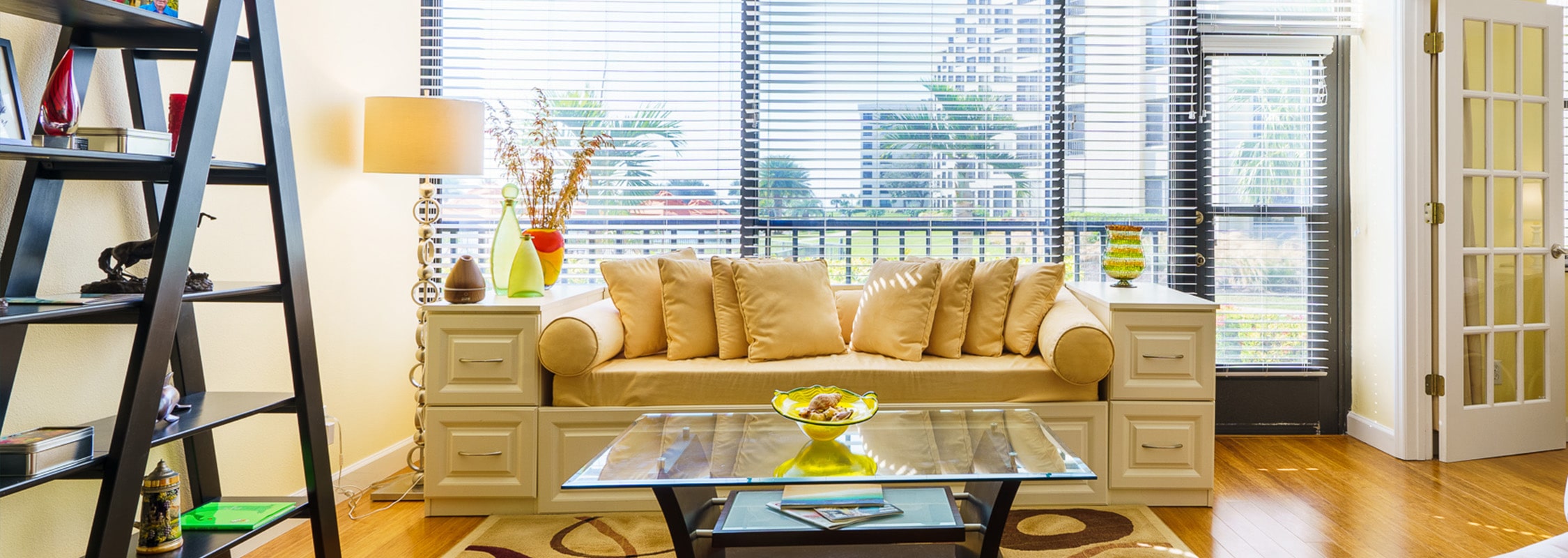 Sun room with large couch by bay windows over looking Siesta Key